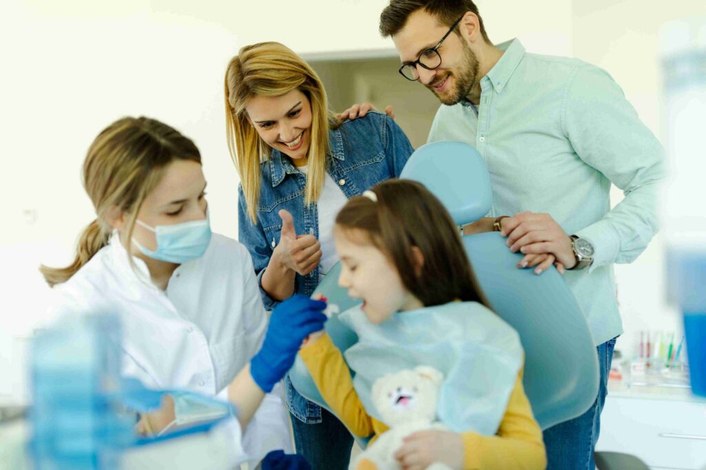 Child receiving dental care with parents during a family dental visit.